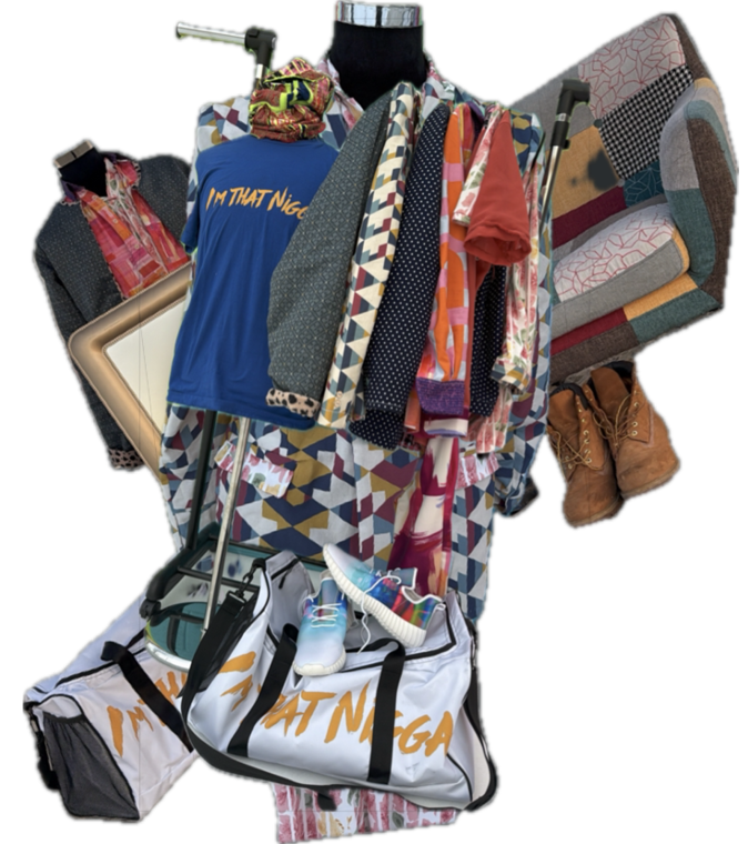 A cluttered arrangement of various clothing items, shoes, bags, a framed picture, and a patterned armchair is displayed on and around a black mannequin stand. Description generated by AI